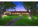 Charming brick home with lush green lawn, mature trees, and a welcoming walkway at 3104 Conners Dr, Las Vegas, NV 89107