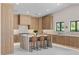 Modern kitchen boasts a large island with seating and light wood cabinetry at 3104 Conners Dr, Las Vegas, NV 89107