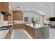 Bright kitchen with stainless steel appliances, wood cabinetry, and large marble island, great for entertaining at 3104 Conners Dr, Las Vegas, NV 89107