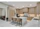 Bright kitchen with wooden cabinets, marble countertops, and an island with bar seating at 3104 Conners Dr, Las Vegas, NV 89107
