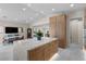 Beautiful kitchen offers a large island with stone countertop and seating and hardwood cabinets at 3104 Conners Dr, Las Vegas, NV 89107