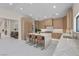 Open kitchen featuring island seating and seamless flow into the dining and living spaces at 3104 Conners Dr, Las Vegas, NV 89107
