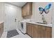 Laundry room equipped with modern washer, dryer, cabinets, sink, and countertop at 3104 Conners Dr, Las Vegas, NV 89107