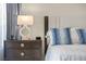 Close-up of a bedroom nightstand with a decorative lamp and blue throw pillows at 3104 Conners Dr, Las Vegas, NV 89107