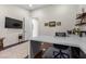 Open and airy home office featuring a large desk, mounted TV, and contemporary decor elements at 3104 Conners Dr, Las Vegas, NV 89107