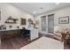 Bright home office with custom built-ins, spacious desk, and comfortable seating area near doors at 3104 Conners Dr, Las Vegas, NV 89107