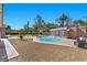 Backyard featuring a pool, brick patio, landscaping, and an outdoor pool house at 3104 Conners Dr, Las Vegas, NV 89107