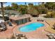 Aerial view of a pool with a pool house surrounded by a brick patio and lounge furniture at 3104 Conners Dr, Las Vegas, NV 89107