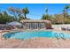 Backyard pool with brick surround, cozy pool house, and tropical landscaping at 3104 Conners Dr, Las Vegas, NV 89107