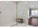 Luxurious shower with marble tiling, glass enclosure, and view into the main bedroom at 3104 Conners Dr, Las Vegas, NV 89107
