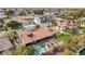 An aerial view displays a tile roof home with lush backyard, pool, spa, and manicured landscaping in a residential area at 3236 Cliff Sieler Ct, Las Vegas, NV 89117