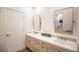 Bathroom boasts double sinks, mirrors, and stylish cabinets with tiled countertops at 3236 Cliff Sieler Ct, Las Vegas, NV 89117