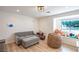 bedroom featuring a comfortable gray couch, drum set, and large window at 3236 Cliff Sieler Ct, Las Vegas, NV 89117