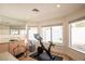 Bright exercise room featuring mirrored walls, windows, and an exercise bicycle at 3236 Cliff Sieler Ct, Las Vegas, NV 89117
