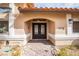 Elegant home entrance featuring a wrought iron double door and brick pathway at 3236 Cliff Sieler Ct, Las Vegas, NV 89117