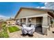 Spacious backyard with a covered patio, charming stone pavers, and green turf, creating a relaxing outdoor oasis at 348 Cadence Vista Dr, Henderson, NV 89011