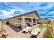 Large backyard featuring a covered patio, ample seating, and well-maintained landscaping, ideal for outdoor gatherings at 348 Cadence Vista Dr, Henderson, NV 89011