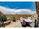 Expansive backyard featuring a covered patio, brick pavers, lush greenery, and a charming brick wall, perfect for relaxation at 348 Cadence Vista Dr, Henderson, NV 89011