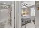 Bathroom featuring a shower-tub combo, grey walls, and white cabinets at 348 Cadence Vista Dr, Henderson, NV 89011