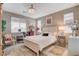 Bright bedroom featuring a crystal chandelier, white furnishings, and multiple windows at 348 Cadence Vista Dr, Henderson, NV 89011