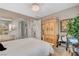 Cozy bedroom showcasing an ornate armoire and a comfortable, well-lit space at 348 Cadence Vista Dr, Henderson, NV 89011