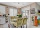Bright dining area with glass table, stylish chairs, and natural light from sliding glass doors at 348 Cadence Vista Dr, Henderson, NV 89011