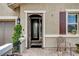 Inviting front entrance with a decorative security door, and desert landscaping at 348 Cadence Vista Dr, Henderson, NV 89011