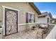 Charming front patio featuring decorative ironwork, a seating area, and a cozy, inviting atmosphere at 348 Cadence Vista Dr, Henderson, NV 89011