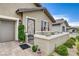 Cozy front patio with desert landscaping, a decorative gate, and comfortable seating for outdoor relaxation at 348 Cadence Vista Dr, Henderson, NV 89011