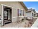 Inviting front entrance with a decorative security door, and a seating area for relaxing outdoors at 348 Cadence Vista Dr, Henderson, NV 89011