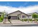 Charming single-story home featuring a well-manicured front yard, desert landscaping, and a two-car garage at 348 Cadence Vista Dr, Henderson, NV 89011