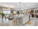 Open-concept kitchen flows into a dining area and living room, featuring granite counters and stainless steel appliances at 348 Cadence Vista Dr, Henderson, NV 89011