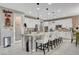 Bright kitchen featuring a large island with white cabinets, granite countertops, and stainless steel appliances at 348 Cadence Vista Dr, Henderson, NV 89011