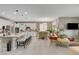 Bright, modern kitchen with white cabinets, granite counters, stainless appliances, and eat-in breakfast bar at 348 Cadence Vista Dr, Henderson, NV 89011