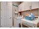 Functional laundry room equipped with modern washer and dryer and ample cabinet space at 348 Cadence Vista Dr, Henderson, NV 89011