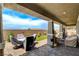 Inviting covered patio with ample seating, stone pavers, and a serene backyard view, perfect for outdoor entertaining at 348 Cadence Vista Dr, Henderson, NV 89011