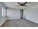 Bright bedroom featuring a window and ceiling fan with plush carpet at 3484 Nightflower Ln # B, Las Vegas, NV 89121
