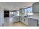 Updated kitchen with stainless appliances overlooking an open living space with brick fireplace at 3484 Nightflower Ln # B, Las Vegas, NV 89121