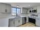 Kitchen with stainless steel appliances, white cabinets, and a large window providing natural light at 3484 Nightflower Ln # B, Las Vegas, NV 89121