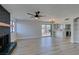 Living room boasts wood-look floors, a black brick fireplace, ceiling fan, and sliding glass doors to the backyard at 3484 Nightflower Ln # B, Las Vegas, NV 89121