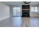 Living room features a black brick fireplace, ceiling fan and sliding door access to the backyard at 3484 Nightflower Ln # B, Las Vegas, NV 89121