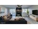 Modern living room features black fireplace, ceiling fan, and large windows at 3484 Nightflower Ln # B, Las Vegas, NV 89121