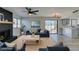 Bright living room with black fireplace, ceiling fan, and sliding door access to the outside at 3484 Nightflower Ln # B, Las Vegas, NV 89121