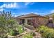 Beautifully landscaped backyard with artificial turf, a charming patio, and a well-maintained exterior at 3486 Molinos Dr, Las Vegas, NV 89141