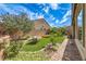 A spacious backyard featuring artificial turf, brick pavers, and well-maintained landscaping with a cozy seating area at 3486 Molinos Dr, Las Vegas, NV 89141