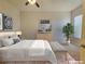 Staged bedroom with neutral colors, patterned bedding, and ample natural light at 38 E Serene Ave # 432, Las Vegas, NV 89123