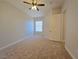 Spacious bedroom with carpet, ceiling fan, and a window providing natural light at 38 E Serene Ave # 432, Las Vegas, NV 89123