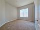 Bright, carpeted bedroom with a window providing natural light and closet space at 38 E Serene Ave # 432, Las Vegas, NV 89123