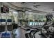 Modern gym with treadmills, elliptical machines, and other equipment overlooking a pool at 38 E Serene Ave # 432, Las Vegas, NV 89123