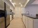 Kitchen featuring stainless steel appliances, granite countertops, and white cabinetry at 38 E Serene Ave # 432, Las Vegas, NV 89123